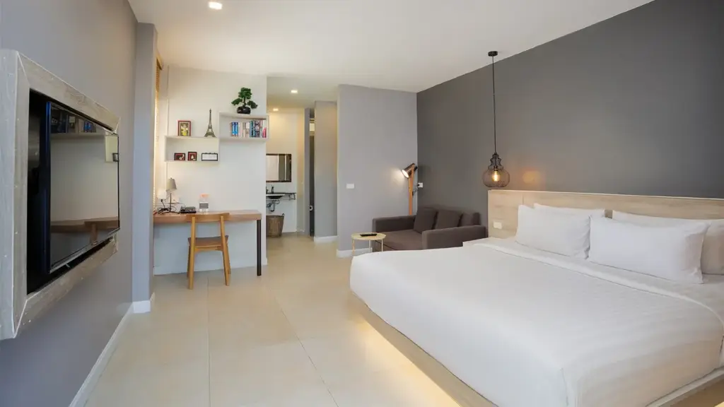 Superior King Room with a king bed, sofa and work desk at Signature Phuket Resort