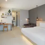 Superior King Room with a king bed, sofa and work desk at Signature Phuket Resort