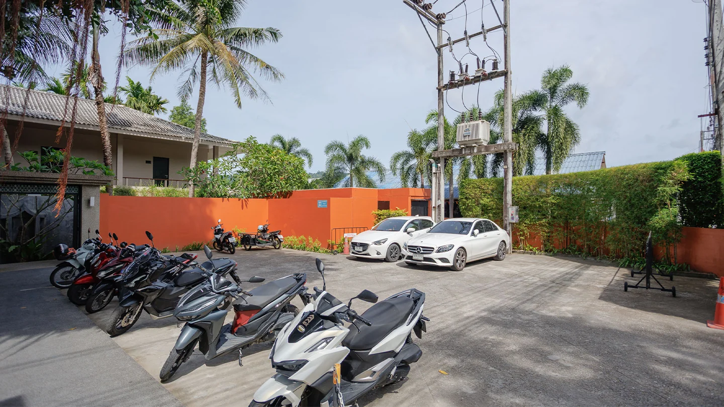 Cars and motorbikes parked at Signature Phuket Resort in Chalong